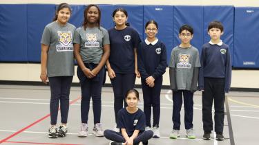 Group of 7 student leaders in the gym, pose for photo