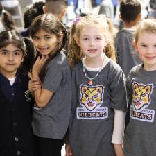 Four K students stand and pose for photo